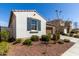 Charming house with a small yard with low maintenance landscaping, shutters, and a window at 21056 W Granada Rd, Buckeye, AZ 85396