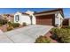 Charming home featuring a low-maintenance landscaped front yard and attached two-car garage at 21056 W Granada Rd, Buckeye, AZ 85396