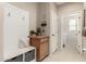 Hallway with coat rack leading to laundry room at 21056 W Granada Rd, Buckeye, AZ 85396