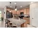 Kitchen island boasts granite counters, stainless appliances, pendant lighting, and a spacious layout at 21056 W Granada Rd, Buckeye, AZ 85396