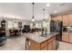 Open-concept kitchen and dining area features granite counters, stainless appliances and seating at 21056 W Granada Rd, Buckeye, AZ 85396