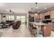 Open-concept living room and kitchen with granite counters, stainless appliances and patio access at 21056 W Granada Rd, Buckeye, AZ 85396