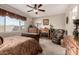 Relaxing main bedroom featuring a ceiling fan, fireplace, and views of the beautiful desert landscape at 21056 W Granada Rd, Buckeye, AZ 85396