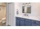 Updated bathroom with navy blue vanity, white countertops, and a tiled shower at 2146 W Isabella Ave # 154, Mesa, AZ 85202