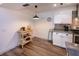 Kitchen and dining area features wood-look tile flooring and white cabinets at 2146 W Isabella Ave # 154, Mesa, AZ 85202