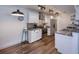 Updated kitchen features granite counters, stainless steel appliances, breakfast bar, and wood-look tile at 2146 W Isabella Ave # 154, Mesa, AZ 85202