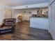 Bright living room with dark wood-style tile flooring and comfortable leather seating at 2146 W Isabella Ave # 154, Mesa, AZ 85202