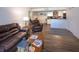 Inviting living room showcasing stylish leather furniture and dark wood-style tile flooring at 2146 W Isabella Ave # 154, Mesa, AZ 85202
