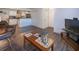 Comfortable living room features dark wood-style tile flooring and open access to kitchen at 2146 W Isabella Ave # 154, Mesa, AZ 85202