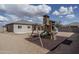 Backyard featuring a wooden playset with swings and slide at 21882 N 260Th Ln, Buckeye, AZ 85396
