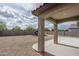 Wide backyard featuring a covered patio and gravel landscaping at 21882 N 260Th Ln, Buckeye, AZ 85396