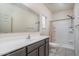 Bathroom featuring a large mirror, a white vanity top and tiled floors at 21882 N 260Th Ln, Buckeye, AZ 85396