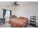 Cozy bedroom with ceiling fan, natural light, and neutral carpeting at 21882 N 260Th Ln, Buckeye, AZ 85396