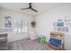 Bright bedroom featuring a ceiling fan, natural light, and cozy decor at 21882 N 260Th Ln, Buckeye, AZ 85396