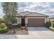 Charming single-story home with a well-maintained front yard and two-car garage at 21882 N 260Th Ln, Buckeye, AZ 85396