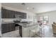 Modern kitchen features granite countertops, stainless steel appliances, and a breakfast bar at 21882 N 260Th Ln, Buckeye, AZ 85396