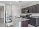 Well-lit kitchen features a spacious granite island with seating and modern appliances at 21882 N 260Th Ln, Buckeye, AZ 85396