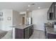 Open kitchen area with stainless steel appliances, granite counters, and an island with seating at 21882 N 260Th Ln, Buckeye, AZ 85396