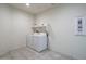 Functional laundry room with washer, dryer, and shelving at 21882 N 260Th Ln, Buckeye, AZ 85396