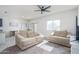 Inviting living room features neutral carpeting, comfortable seating, and a view of the backyard at 21882 N 260Th Ln, Buckeye, AZ 85396