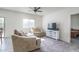 Bright living room with neutral tones, comfortable seating, and a ceiling fan at 21882 N 260Th Ln, Buckeye, AZ 85396