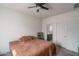 Spacious bedroom features carpet, a ceiling fan, and an ensuite bathroom at 21882 N 260Th Ln, Buckeye, AZ 85396