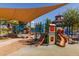 Colorful playground with slides, climbing structures, and shade canopies for outdoor fun and recreation at 21882 N 260Th Ln, Buckeye, AZ 85396