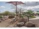 Community playground featuring a slide, shade structure, and a variety of recreational activities for children at 21882 N 260Th Ln, Buckeye, AZ 85396