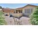 Desert landscaped backyard featuring a covered patio, block fence, and low maintenance yard at 2380 E Seville Ct, Casa Grande, AZ 85194