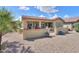 View of backyard featuring a covered patio, block fence, and desert landscaping at 2380 E Seville Ct, Casa Grande, AZ 85194