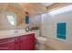 Stylish bathroom featuring a red vanity, textured walls, and shower at 2380 E Seville Ct, Casa Grande, AZ 85194