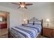 Cozy bedroom with ceiling fan, closet, and ensuite bathroom at 2380 E Seville Ct, Casa Grande, AZ 85194