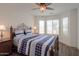 Bedroom with dark wood floors, ceiling fan, and bay windows at 2380 E Seville Ct, Casa Grande, AZ 85194
