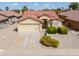 Well-maintained home with desert landscaping, two-car garage, and red tile roof in a quiet neighborhood at 2380 E Seville Ct, Casa Grande, AZ 85194