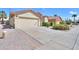 Desert landscaping and wide driveway complement this single-story home with a red tile roof at 2380 E Seville Ct, Casa Grande, AZ 85194