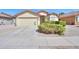 Single-story home with desert landscaping, well-kept shrubbery, and a two car garage at 2380 E Seville Ct, Casa Grande, AZ 85194