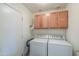 Convenient laundry room with cabinets, a washing machine, and a dryer at 2380 E Seville Ct, Casa Grande, AZ 85194