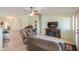 Open-concept living room with a fireplace, comfortable seating, and tile flooring at 2380 E Seville Ct, Casa Grande, AZ 85194