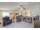 Bright living room with tile floors, ceiling fan, comfortable seating and access to the kitchen at 2380 E Seville Ct, Casa Grande, AZ 85194