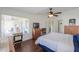 Bright main bedroom featuring wood-look flooring, dual pane windows and a ceiling fan at 2380 E Seville Ct, Casa Grande, AZ 85194