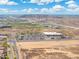 An aerial view shows the neighborhood near commercial buildings and desert terrain at 2523 W Running Deer Trl, Phoenix, AZ 85085