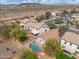 Scenic aerial view of a backyard oasis with a kidney-shaped pool, surrounded by lush greenery at 2523 W Running Deer Trl, Phoenix, AZ 85085