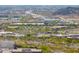 An aerial view shows a bustling commercial area with shopping centers, desert landscape, and traffic at 2523 W Running Deer Trl, Phoenix, AZ 85085