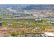 Expansive aerial view captures the property amidst a vibrant city, rolling hills, and bustling highways at 2523 W Running Deer Trl, Phoenix, AZ 85085