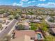 Beautiful aerial view of homes in community, lush trees, and sparkling blue pool at 2523 W Running Deer Trl, Phoenix, AZ 85085