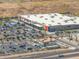 An aerial view captures a shopping center with ample parking and diverse stores at 2523 W Running Deer Trl, Phoenix, AZ 85085
