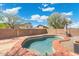 Backyard featuring a private pool surrounded by a brick fence and beautiful landscaping at 2523 W Running Deer Trl, Phoenix, AZ 85085