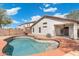 Backyard view of private pool with a kidney-shaped design and a covered patio at 2523 W Running Deer Trl, Phoenix, AZ 85085