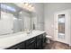 Bright bathroom featuring black cabinetry, a large mirror, and modern fixtures at 2523 W Running Deer Trl, Phoenix, AZ 85085