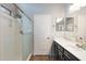Bathroom with shower, black vanity cabinet and white countertop at 2523 W Running Deer Trl, Phoenix, AZ 85085